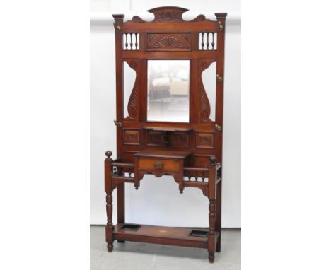 An early 20th century mahogany Arts and Crafts hall stand, carved fan top above central mirror decorative cut outs to either 