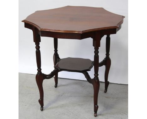 An early 20th century shaped octagonal red walnut table with reeded turned legs united by a shelf stretcher, width 73.5cm.