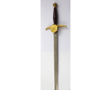 A Wilkinson Fraternal sword with engraved blade and wooden handle, the guard engraved 'TFC', length of blade 70cm.