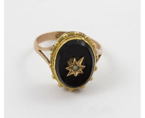 A 9ct gold mourning ring with oval onyx inset and tiny seed pearl, size P, approx 3.6g.