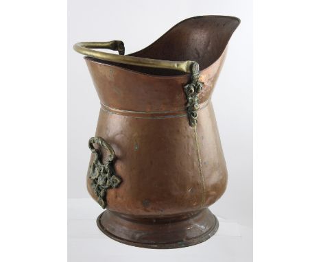 A large 19th century hand-stitched copper and heavy cast brass helmet-shaped coal scuttle, height 57cm.