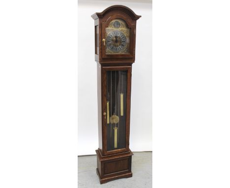 A modern oak longcase clock, the arched dial set with Roman numerals, three-train movement striking and chiming on rods, with