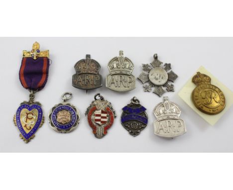 A group of medals and military badges to include two silver ARP badges and a similar lapel badge, a Denton Cricket Club 1931 