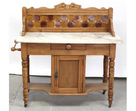 A Victorian pine marble-top tile-back washstand with single central cupboard flanked by turned legs united by a shelf stretch