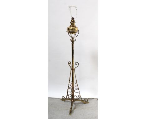 An early 20th century brass and copper Arts and Crafts style standard lamp with non-matching converted oil lamp top, height 1
