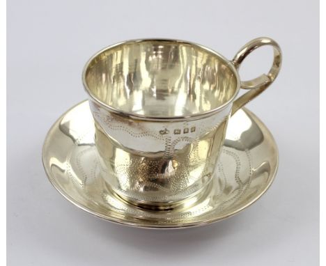 A George V hallmarked silver coffee cup and saucer with engine-turned abstract and foliate decoration, Moshe Rubin, London 19
