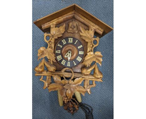 A black forest cuckoo clock, the heavily carved case in the form of a Swiss chaletLocation: 