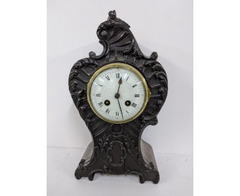 A late 19th century mahogany mantel clock the case carved with C scroll and the Japy Freres 8-day movement striking on a sing