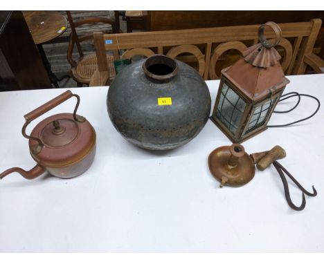 A selection of metal ware to include an African water carrier metal bowl, copper porch light with glazed panels, chamberstick