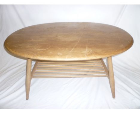 A 1960's Ercol light elm oval two-tier coffee table