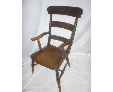 A Victorian elm &amp; beech kitchen carver armchair with rail back and shaped seat on turned tapered legs