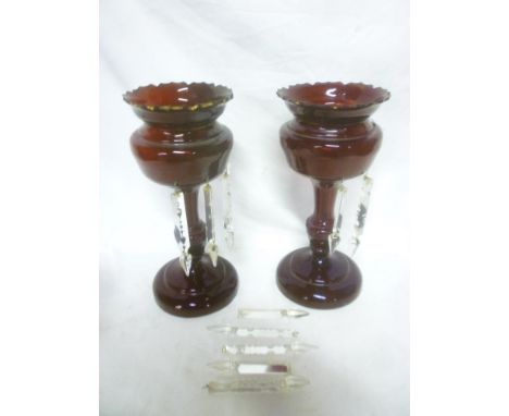 A pair of Victorian ruby tinted glass baluster-shaped table lustres with glass lozenge droplet decoration