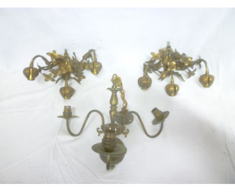 A pair of ornate brass three-branch wall lights with raised floral decoration and one other brass three-branch centre light (