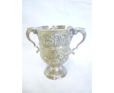 A mid 19th Century Irish silver two-handled pedestal cup decorated in relief with scrolls and flowers, Dublin marks, maker "T