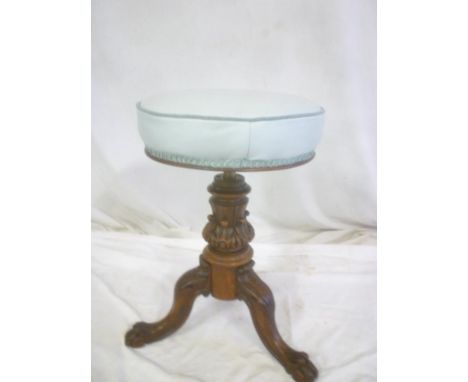 A Victorian carved mahogany and brass mounted circular revolving piano stool on tripod base