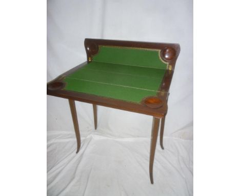 An ornate Edwardian inlaid mahogany double opening card table with baize lined playing surface on square tapered legs 
