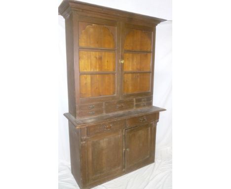 A Victorian stained pine kitchen dresser with two drawers in the frieze and cupboard enclosed by two panel doors, the upper p