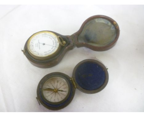 A brass pocket barometer by Negretti &amp; Zambra of London in fitted leather case and a small pocket dry card compass (2)