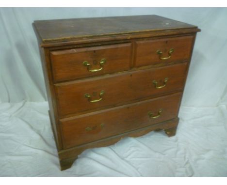 A small stained pine chest of two short and two long drawers on bracket feet
