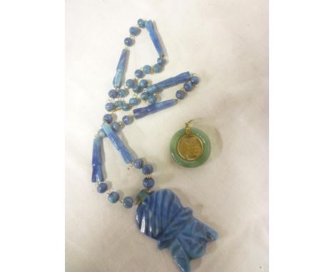 A Chinese Jade mounted circular pendant and an Eastern blue jade pendant necklace