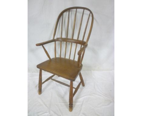 An early 19th Century elm &amp; ash Windsor armchair with spindle back and polished wood seat on turned legs