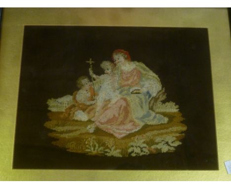 A Victorian needlework rectangular panel depicting a female figure with two children, framed and glazed