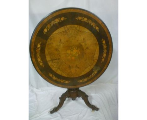 A Victorian Marquetry inlaid walnut circular turnover top occasional table with floral decorated top on turned columns with t