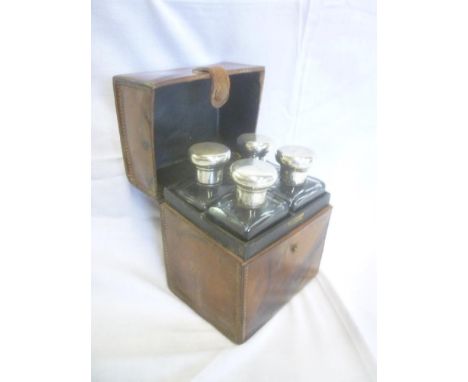 A set of four silver mounted glass rectangular travelling bottles, London marks 1920 in fitted leather case by Mappin &amp; W