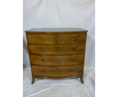 A Victorian figured mahogany bow-front chest of two short and three long drawers with brass ring handles on bracket feet