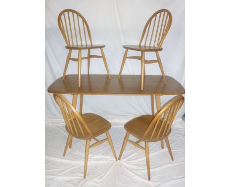 A 1960's Ercol light elm rectangular dining table together with four Ercol spindle back dining chairs