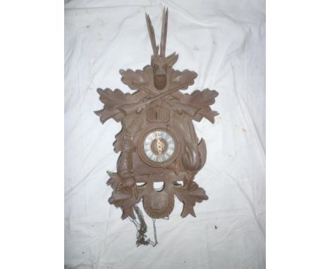 A Continental carved wood Cuckoo clock with raised figure decoration 