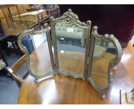 A GILT FRAMED TRIPTYCH DRESSING TABLE MIRROR, A MAHOGANY OVAL BEVELLED EDGE WALL MIRROR AND AN ANGLEPOISE DESK LAMP (3) 