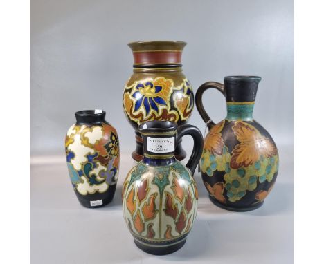 Collection of Gouda Dutch pottery items, all with multi-coloured floral and similar designs to include: two jugs and two vase