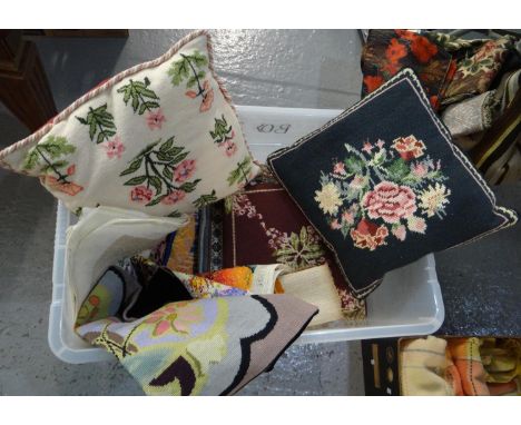 Large box of woollen tapestry needlepoint embroidered cushions; various designs to include: floral, cat etc. Some partially c