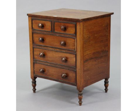 A 19th century mahogany commode enclosed by a hinged lift-lid &amp; mock-drawer front, &amp; on turned feet, 23” wide x 29” h