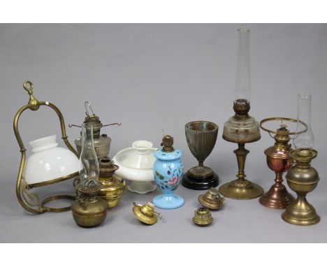 A collection of eight various vintage oil lamps, and various oil lamp accessories.