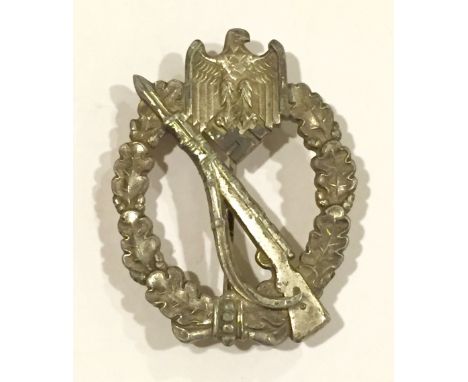 German Third Reich WW2 Army / Waffen SS Infantry Assault Badge. A good silver plated die-cast example with vertical needle pi