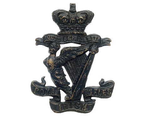 Badge. Badge. Royal Irish Rifles, Victorian OR’s glengarry badge circa 1881-96. Die-stamped blackened brass crowned scroll “Q