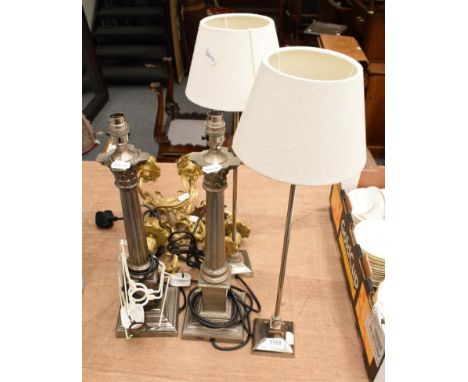 A pair of Laura Ashley silvered column table lamps, another pair of modern table lamps, a pair of cast gilt metal three light