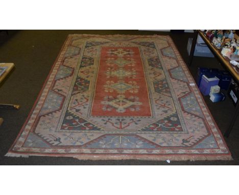 Melas carpet, the terracotta field with five medallions enclosed by wide reciprocal borders, 354cm by 241cm     