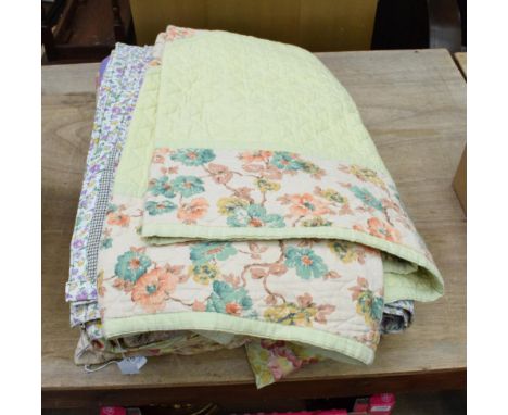 Circa 1930s patchwork cover in bright coloured florals, purple and purple floral to reverse; another with red and white paisl