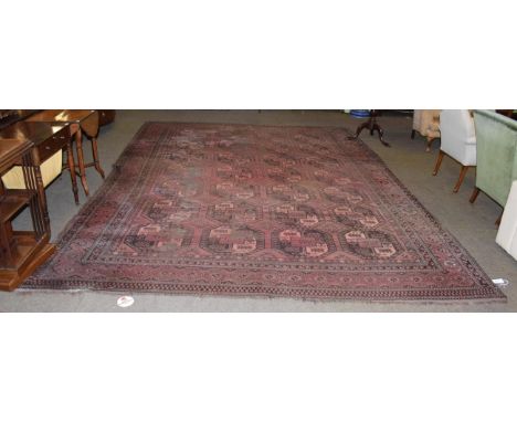 Afghan Turkman carpet, circa 1900, the field  with columns of elephant foot guls enclosed by borders of stellar motifs, 420cm