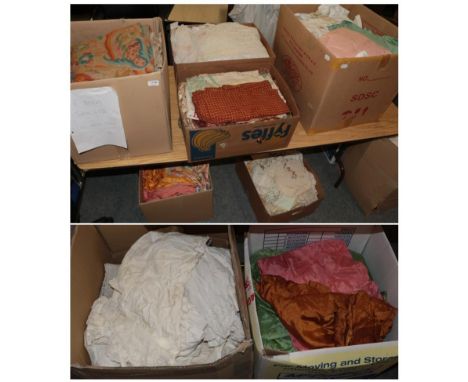 A large quantity of assorted mixed textiles including linen and cotton bedding, table cloths, curtains, pink eiderdown, embro