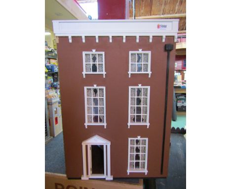 A three storey dolls' house with a small quantity of furniture and a ceramic bathroom suite 