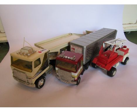 Two metal model articulated trucks and a fire engine