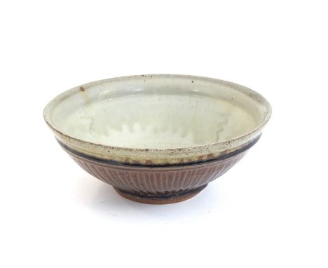 Mike Dodd (b.1943), a large studio pottery bowl, carved outside, tenmoku glaze with celadon interior, maker's mark MD, 28cm d