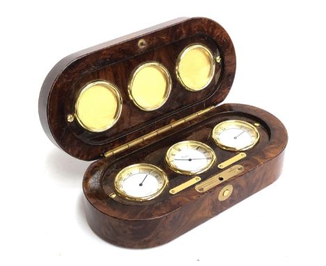A burr walnut Asprey desk clock set, containing three Swiss made clocks, the central dial with Roman numerals, the two outer 
