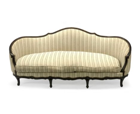 A Moissonnier d'Aurevilly three seater sofa, with a carved ebonised beech frame, in a striped print, raised on carved cabriol