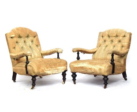 A matched pair of 19th century armchairs in the manner of Howard &amp; Sons, each with loose cover, button back, the open arm