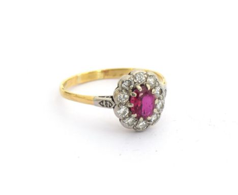 An 18ct gold ruby and diamond cluster ring, unmarked but tests as 18ct gold, size O, 2.2g 